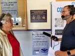 Mary Paczesniak, pictured with Think Out Loud host Dave Miller at Marshfield High School, is on a mission to make sure female athletes get their due. That includes making sure that every time the school's mascot, a pirate, is added to a sign, the image of a lady pirate is added as well.