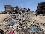 Piles of uncollected garbage and debris line a deserted street in al-Shuja'iyya, a neighborhood, lacking basic services and aid due to israel restrictions as expanding the orange zone.<br>