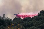 Fire air planes and helicopters drop water over flames in Topanga Canyon during Palisades wildfire in Topanga, Los Angeles, Calif., United States on Friday.