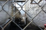 Tanks at the Vigor Industrial shipyard's oily wastewater treatment operation sit behind a cyclone fence. The company shut down its treatment of third-party wastewater for the benefit of neighbors, who complained about the odor.