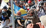 In this Aug. 12, 2017 file photo, white nationalist demonstrators clash with counter demonstrators at the entrance to Lee Park in Charlottesville, Va.