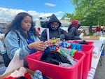 Volunteers with the Bethesda World Harvest International Church sort through boxes of donated clothes to hand out to members of the community.