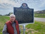 Jerry Smith stands by a historical marker that describes how civil rights activist William Lewis Moore died in 1963.