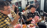 Ed Kim films his mom Jane for their social media account "The Korean Mama" at Sebastiano's in Portland, Ore. April 2, 2024