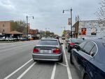 The paint marking the lane is faded and in some places non-existent and speeding cars, as you can see here, often drift into the bike lane. The city of Chicago recently installed new stop signs in the area to slow cars down, and may put plastic bollards between the car and bike lanes.