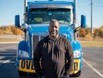 Heavy haul trucker Eric Jammer stands in front of his truck.