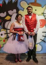 David Morley and Andrea Yip posed in front of the Sanrio wall.
