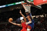 Portland Trail Blazers forward Toumani Camara, left, drives to the basket as Denver Nuggets forward Aaron Gordon defends during the second half of an NBA basketball game Saturday, March 23, 2024, in Portland, Ore. The Denver Nuggets won 114-111.
