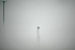 A pedestrian walks along the roadside amid heavy smoggy conditions in New Delhi. Delhi is considered the world's most polluted megacity, with a melange of factory and vehicle emissions exacerbated by seasonal agricultural fires.