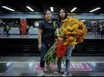 A mother and daughter travel on the city's metro's women-only section with flowers from Mercado Jamaica for Día de los Muertos in October 2023.