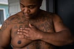 Lionel Irving shows his tattoos on July 1, 2019, in North Portland. Irving is trying to interrupt the cycle of violence in his community that led him to join a gang at a young age.