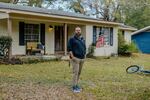 Former Marine Jason Miles stands in front of his home in Clinton, Miss. He lost a sales job during the pandemic and had to take a forbearance.