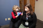 Nurse Elizabeth Vadnais administers the COVID-19 vaccine to fellow nurse Ashlynn Strode of Providence Southwest Washington.