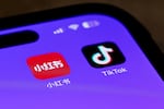 Icons for the smartphone apps Xiaohongshu and TikTok are seen on a smartphone screen in Beijing, Tuesday, Jan. 14, 2025.