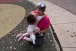 Viktoriia Ivana holds her daughter Bohdana, 5, on the playground at Larkspur Park on Oct. 17, 2026, in Bend, Ore.