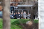 FBI agents gather in front of the house where they made an arrest, in Woodbridge, Va., Thursday, Dec. 4, 2025.