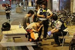 Sat., Oct. 7: A young woman reacts as she speaks to Israeli rescuers in Tel Aviv.