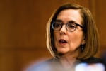 Oregon Gov. Kate Brown speaks to reporters from her ceremonial office in the state Capitol in Salem, Ore., Monday, Jan. 14, 2019.