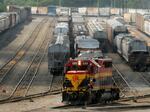 A worker climbs aboard a locomotive at a CPKC rail yard on Wednesday, Aug. 21, 2024, in Kansas City, Mo.