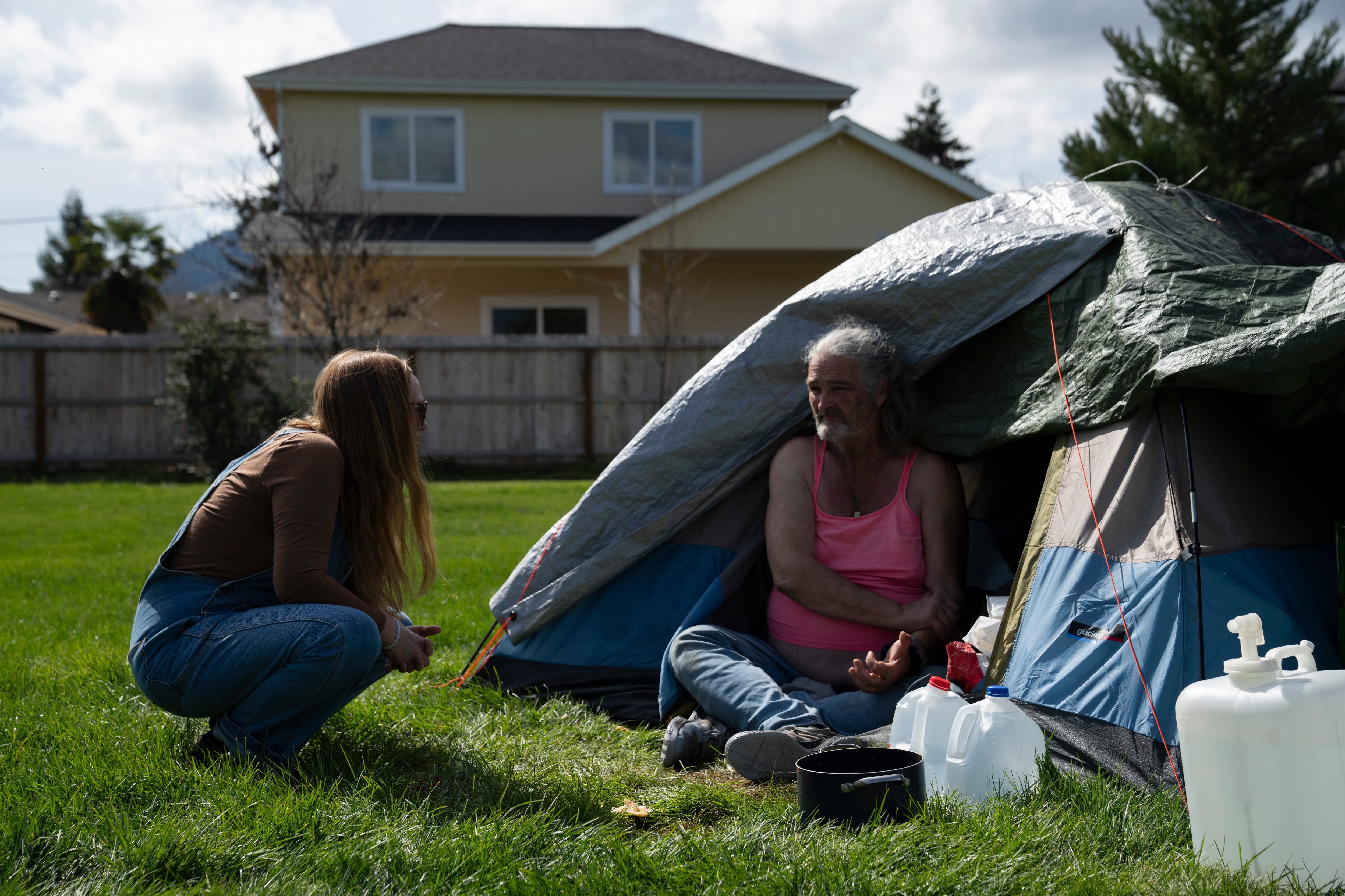FILE - Cassy Leach, a nurse who leads a group of volunteers who provide food, medical care and other basic goods to the hundreds of homeless people living in parks, talks to Kimberly Marie, who is homeless and camping in Fruitdale Park, on March 21, 2024, in Grants Pass, Ore. On Friday, June 28, the Supreme Court ruled that cities can enforce bans on homeless people sleeping outdoors in areas where shelter space is lacking.