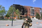 A Ukrainian soldier walks past damaged buildings in central Pokrovsk, the site of the heaviest battles with the Russian troops in the Donetsk region, Ukraine, Wednesday, April 23, 2025.