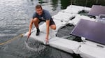 Oregon Institute of Technology student Juan Villarreal holds the aeration hose that will add dissolved oxygen to Upper Klamath Lake. 