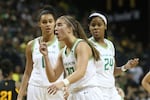 Oregon's Sabrina Ionescu, center, with Satou Sabally, left, and Ruthy Hebard, right, questions a call during the third quarter of an NCAA college basketball game against Arizona State in Eugene, Ore., Sunday, Feb. 9, 2020.