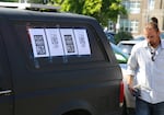 Nicholas Schindler places signs on his car outside Bend City Hall, protesting the planned removal of a homeless encampment on Hunnell Road. Schindler said he's lived on Hunnell Road for nearly three months.