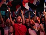 Supporters of French far-right leader Marine Le Pen react after vote projections in select constituencies, Sunday, in Henin-Beaumont, northern France. French voters propelled the far-right National Rally to a strong lead in first-round legislative elections Sunday and plunged the country into political uncertainty.