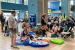 July 23, 2023: Tourists wait in the airport's departure hall as evacuations are underway due to wildfires, on the Greek island of Rhodes.