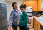 Kristen Palmer and her son Jordan, 7, at their Sellwood home, Nov. 8, 2023. Palmer, a full-time college student, is juggling her studies while Jordan, a second grader at Llewelyn Elementary School in Southeast Portland, is not able to attend classes due to the strike. 