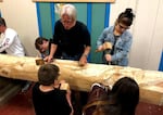 In this Oct. 10, 2018 photo, then-master carver Vic Hansen oversees several 4J NATIVES students as they carve a large piece of wood that will eventually become a totem pole.