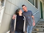 Rodger Kennedy (right) stands next to his son, Sam, a student in OPB's Class Of 2025 project, outside their apartment in Springfield, Ore.