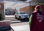 A PIRC volunteer watches as a vehicle exits the Immigration and Customs Enforcement building on Oct. 7, 2026 in Portland, Ore.