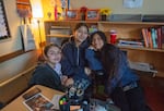 From left: Freshman student Beverly, senior Tiffany, and sophomore Angeline pose in the Latinx Student Union classroom at David Douglas High School on Nov. 18, 2024. The students sit and eat lunch together daily in the room, which serves as a place of support and resources for Latinx students.