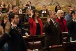 Patricia Poprik (center), who is serving as a repeat presidential elector for Trump, takes an oath with other 2016 Republican electors at the Pennsylvania state Capitol in Harrisburg, Pa.