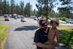Duncan MacDougall holds his three-year-old son, Zion Naoupu, as they walk into the evacuation shelter at the school. Their home, which is on the edge of Level 1 “Ready” and Level 3 “Go Now” evacuation order zones, is so far okay, MacDougall says.