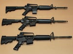 Texas Gov. Greg Abbott says the gunman responsible for the Uvalde shooting Tuesday used an AR-15-style assault rifle. Here, three variations of the AR-15 are displayed at the California Department of Justice in Sacramento, Calif., in 2012.