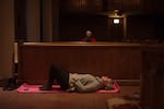 Participants lay on yoga mats on the floor of the soaring sanctuary of the Episcopal Church of the Ascension in Knoxville, Tenn, for breath-work practice. The once-monthly evening event is called Breathing Under Stained Glass.