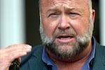 Right-wing conspiracy theorist Alex Jones speaks outside the federal courthouse after a June bankruptcy hearing in Houston.