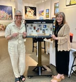 Camas-based artist Lara Blair and Kim Nickens, the co-owner of Gallery 408 in Camas, pose for a portrait on May 20, 2026 at Gallery 408 in this provided photo. Blair designed a miniature version of the art gallery featuring tiny painted canvases , sculptures and other objects she and 12 other local artists, including Nickens, contributed for the installation which was publicly unveiled in Camas on June 5, 2026.
