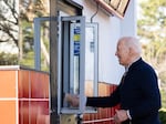 President Biden shakes hands through a take-out window after ordering food from Cook Out in Raleigh, N.C. on Jan. 18, 2024.