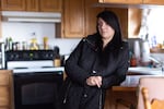Charlotte Groo stands in the kitchen of her adoptive parents’ Bonnie and Charlie Groo’s Yakima, Wash. home. Growing up, Charlotte, 24, lived off and on with missing Indigenous teenager Kit Nelson-Mora at Bonnie and Charlie’s home.