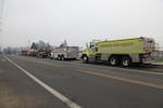 Water tankers and other firefighting trucks line up outside the high school in Brookings.