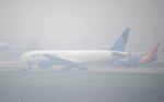 Jetliners taxi in heavy smoke at Denver International Airport Friday, May 19, 2023, in Denver.