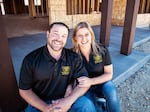 Home builder Tom Stringham sits with his wife Angela Stringham in front of a home his company is building in Montana.