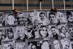 An art installation, which displays black and white images of people detained or deported as a result of ICE raids in Southern California, stands outside the federal building in Los Angeles, Thursday, July 17, 2025.