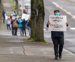 Community member Andrew Brown attends a rally in support of Portland city workers at the Bureau of Transportation’s Stanton Yard in North Portland, Jan. 18, 2022. District Council of Trade Unions’ negotiations with the city have reached an impasse and DCTU will hold a strike authorization vote. DCTU represents approximately 1,100 city employees.