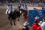 Keenan Hayes of Colorado holds onto the horse, Midnight Special, as he bursts out of the chute in the bareback event on Friday.
