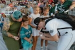 LA Queens player signs autographs for fans in the crowd of Robin Roberts Stadium during the San Francisco Firebells-Boston Hunters game of the Women's Pro Baseball League. Springfield